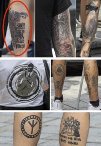 Identitärendemo 29.7.23: Wochenspruch der NSDAP, Schwarze Sonne, Odalrune, T-Shirt der Neonazi-band Erschiessungskommando, Tyr-Rune, Algiz